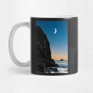 Moon over a rock and ocean Mug